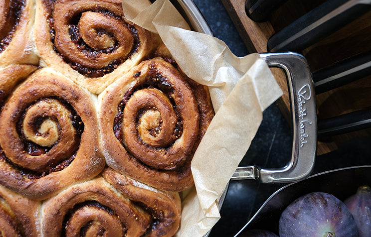 Freshly baked cinnamon rolls in a 316 Low Casserole with parchment paper.
